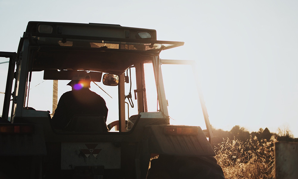 Agricultural contractors operating a tractor